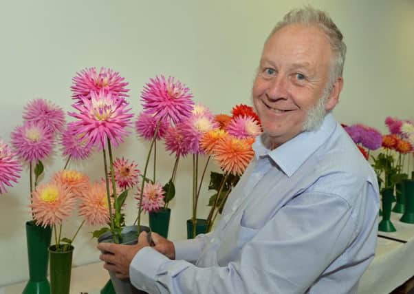 Charles Holmes shows off his prize winning dahlias at the Larne Flower Show. INLT 34-032-PSB