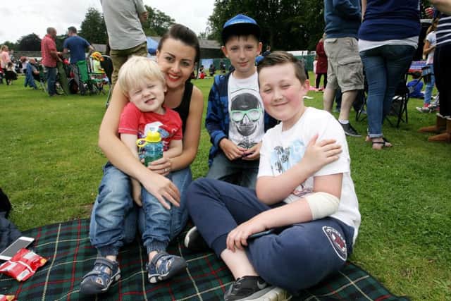 Emma Harrison, Charlie Harrison, Benjamin Attree and Matthew Magee taking time out for a photo at the Party in the Park in Antrim Castle Gardens. INBT35-248AC