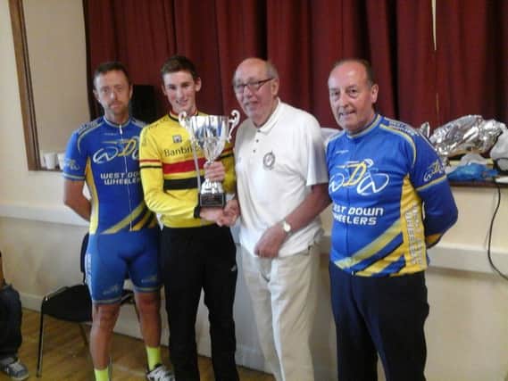 James Curry receives the West Down GP trophy from cycling legend Morris Foster MBE. Left is Paul Wilkinson, who finished fourth and right is Wheelers chairman Billy Maxwell.