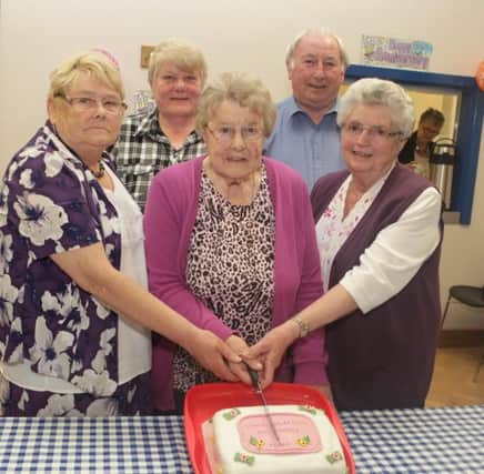 ANNIVERSARY. Pictured cutting a cake to mark the 10th Anniversary of Ballybogey Over 50's Club on Thursday night are Founder members, Eleen McIntyre and Edith Pollock along with Office Bearers, Alma McCook, Claire Campbell and Hopkins Stewart.INBM35-15 024SC.