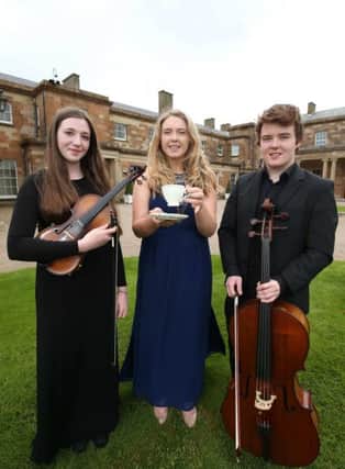 Soloist Zoe Jackson with Ulster Youth Orchestra members Grainne White (left) and Angus McCall (right).