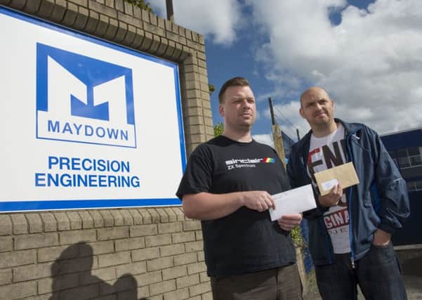 Alastair Robinson and Darren Cowey handing over letters of protest during one of the recent demonstrations held by Unite at Maydown Precision Engineering.