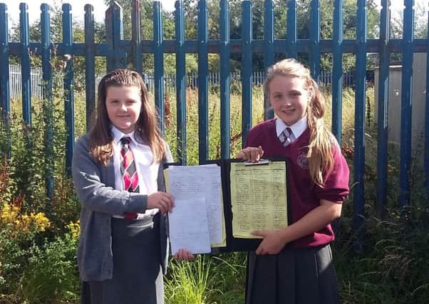 Katelyn Ramsey and Brooke Smith with their petition for a play park at the Eden site.  INCT 35-723-CON