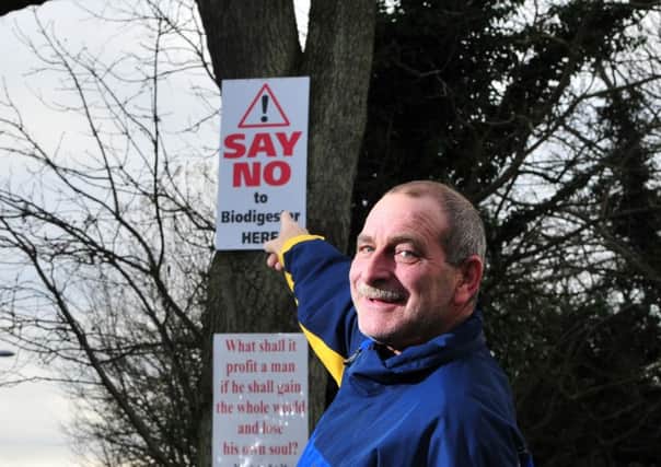 Ballynakelly resident Trevor Stratton points to the "Say No to the Biodigester Plant Here" sign
