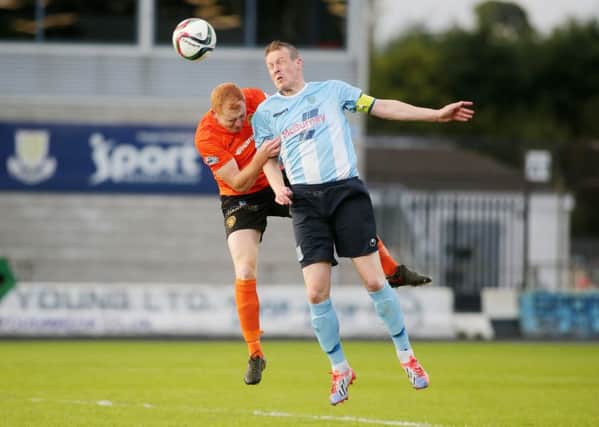 Ballymena United's Allan Jenkins wins this header against Carrick's Joe McNeill during Friday night's match at the Showgrounds.Picture: Press Eye.