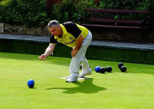 A Dunbarton bowler in action against Ulster Transport.