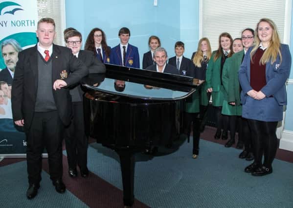 Barry Douglas at the piano with pupils at the launch of the Harmony North project at Hazelwood Integrated College. INNT 35-515-SO