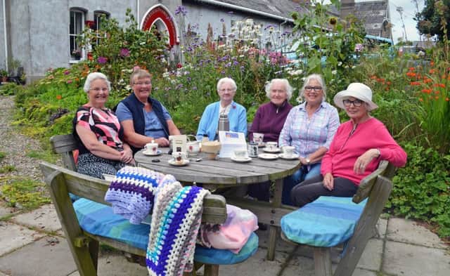 The best kept community planting scheme winner at the Carrickfergus in Bloom community competitions was Charles Sheils Charity, included is Christine Harper (second from right) with Sheils residents. INCT 35-751-CON