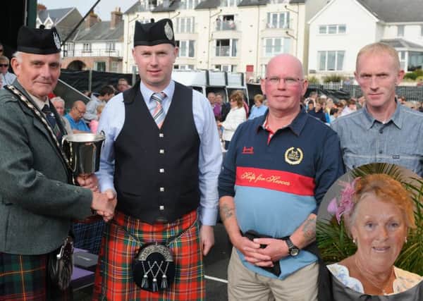 Wayne Byrne pictured presenting a new perpetual cup on behalf of Marlacoo & District Pipe Band in memory of his mother, the late Florence Byrne to Winston Pinkerton (RSPBANI President) at the North West Pipe Band & Drum Majors Championships at Portrush on Saturday 22nd August.  Looking on are Waynes brother Gregory and their father Michael.  Inset pic: The late Florence Byrne.