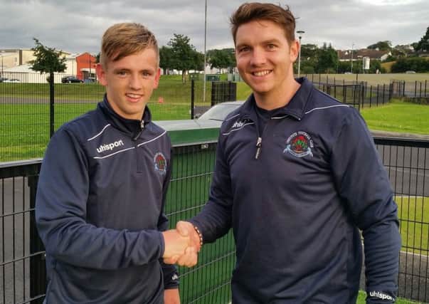 Institute manager Kevin Deery welcomes new signing Ciaron Harkin to the club.