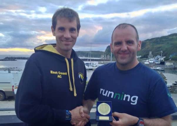 Justin Maxwell congratulates Murray Deller on his top 10 finish at the Rathlin Run. INLT 36-930-CON
