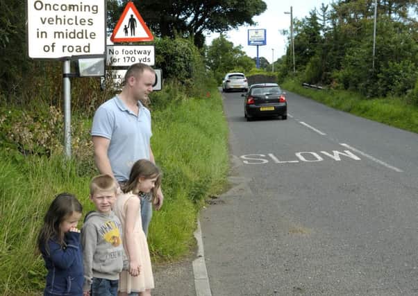 Graham Ford and his Children, Ellie, Logan and Morgan try to cross the  busy road at Ballycarry Train Station. INLT 35-225-AM