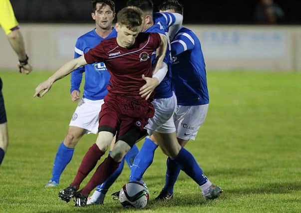 Institute's Aidan McCauley tries to get away from two Limavady United players during their Senior Cup game on Friday night. INLV3615-186KDR