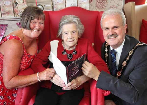 Gladys Holmes, celebrated her 100th birthday during the weekend at Annahilt Care Home with her daughter Helen Allan and Mayor Thomas Beckett. US1535-507cd  Picture: Cliff Donaldson