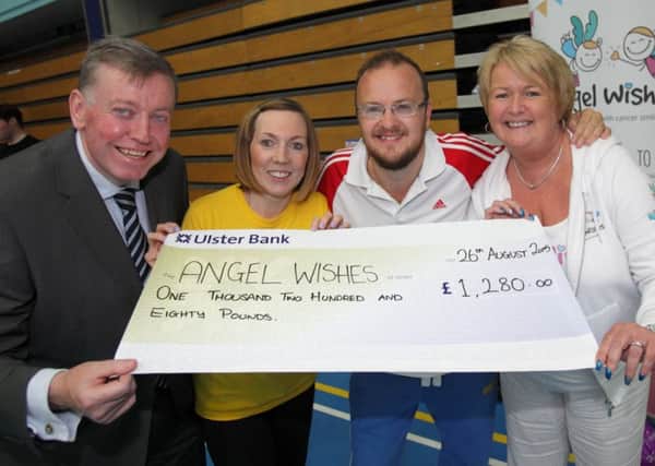 Cllr Paul Porter with Emma and Chris Canning, organisers of a charity dodge-ball tournament at Lisburn Leisureplex, handing over a cheque to Gaye Kerr from Angel Wishes. US1534-562cd  Picture: Cliff Donaldson