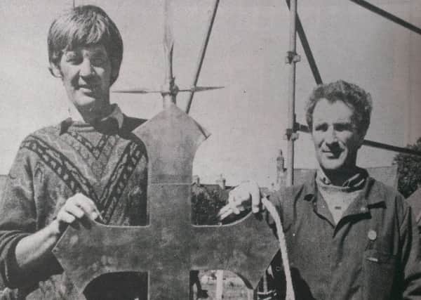 Jack Colgan (left) and Francis McCaw are pictured preparing to hoist the new filial on to the spire at St Nicholas' Parish Church. INCT 35-759-CON