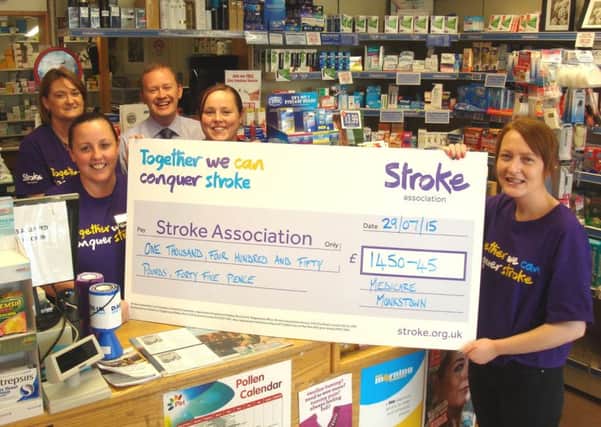 MediCare Monkstown employees Mandy Clarke, Jacky Rea, Stephen Houston (pharmacist) and Lisa Millar hand over a cheque for £1,450.45 to Kate Gorman of the Stroke Association NI. INNT 37-501CON