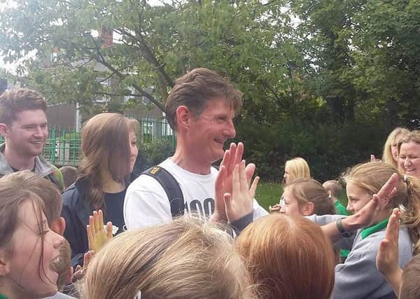 Dermot Breen is welcomed back to Greenisland Primary at the conclusion of his 1000km fundraising walk in memory of his wife, Jacqui, a former teacher at the school.  INCT 36-720-CON