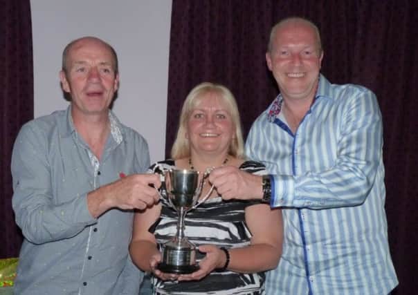 Larne Tennis and Lawn Bowls tennis section captain Julie Jenkins presents Paul Blair and Ricky Kelly with their trophy. INLT 37-910-CON