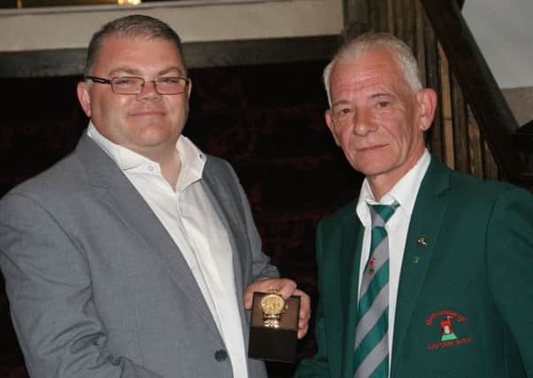 Redcastle's Captain Mr William Watson presenting first place prize to Paddy Canning.