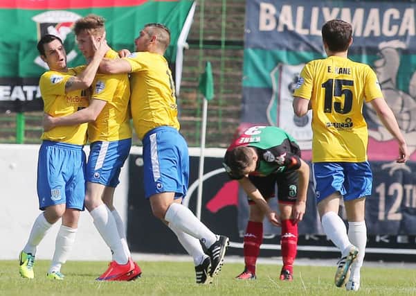 Matthew Shevlin is mobbed by his Ballymena United team-mates after scoring his side's equaliser in today's game against Glentoran at the Oval. Picture: Press Eye.