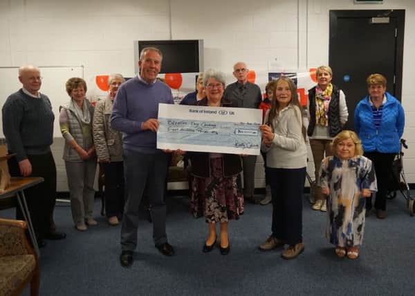 Mrs Margaret Calvert presenting a cheque for £300 to Breathe Easy. Also in the picture, from left Mr Sam Kelly, Treasurer,  Mrs Christine Archibald, Chairperson, Janis Dallas and other Group members.