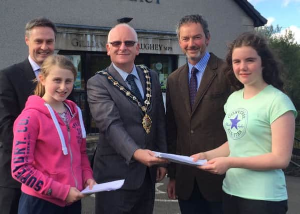 Mayor Billy Ashe is presented with letters from residents of Kells & Connor calling for improved play park facilities in the villages. (Submitted Picture)