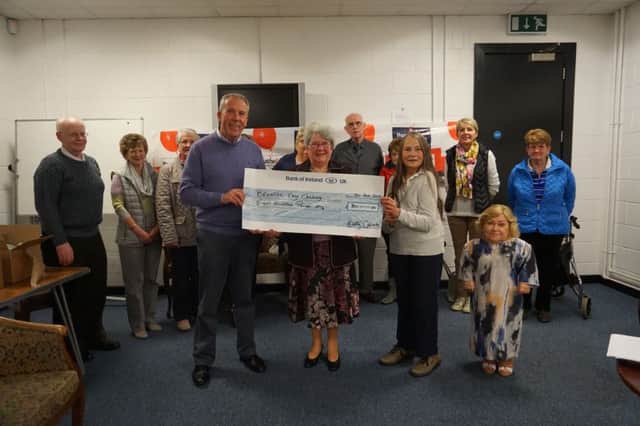 Mrs Margaret Calvert presenting a cheque for £300 to Breathe Easy. Also in the picture, from left Mr Sam Kelly, Treasurer, Mrs Christine Archibald, Chairperson, Janis Dallas and other Group members.