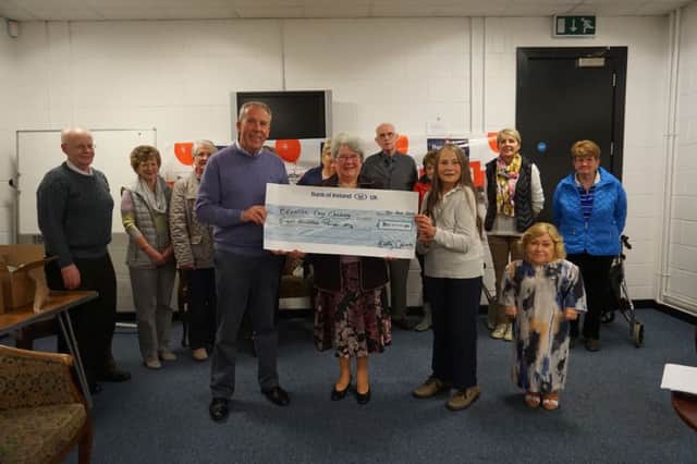 Mrs Margaret Calvert presenting a cheque for £300 to Breathe Easy. Also in the picture, from left Mr Sam Kelly, Treasurer,  Mrs Christine Archibald, Chairperson, Janis Dallas and other Group members.