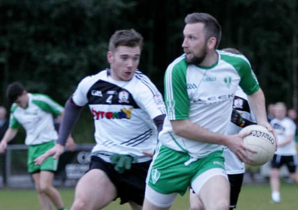 Oisín Crilly looks for an opening in the Ardoyne defence.