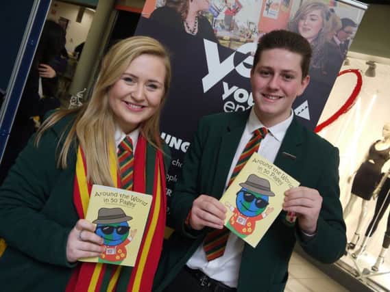 Jake Lewis and Ruth Wells from Friends showcase their company ActiKids with their travel activity journal Around the World in 50 Pages at a Young Enterprise Trade Fair event held at Bloomfield Shopping Centre in February.