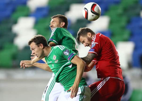 Northern Ireland's Gareth McAuley and Jonny Evans with Hungary's Tamas Kadar during Monday night's Euro 2016 qualifier game. INLT 37-946-CON
