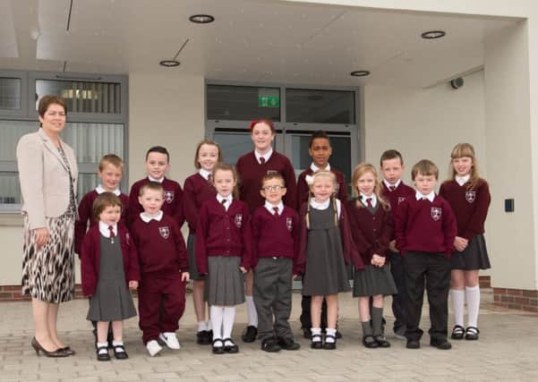 Representatives of classes P1 to P7 pictured along with Principal Mrs Doran at the front of the new school building at St.Teresa's Primary School. INLM3715-408