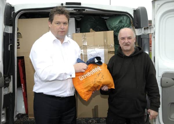 Alderman Mark Cosgrove and Tommy Mooney loading supplies bound for the refugees in Calais, France. INNT 36-210-AM