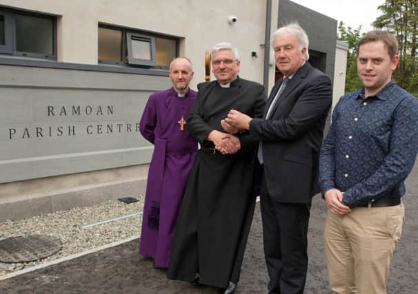 KEY MOMENT. David Hamilton, MD of Contractors Martin & Hamilton hands over the keys of Ramoan Parish Centre on Thursday night to Minister Rev David Ferguson with Bishop of Connor Rev Alan Abernethy and Patrick Donagy of Consarc Architects looking on.INBM37-15 006SC.