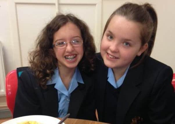 Making new friends on their first day in Downshire School are Naomi Parkes, 8O and Amber Gilchrist, 8W. INCT 37-709-CON