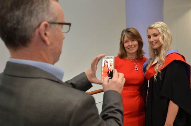 HND Hair and Beauty Management graduate Victoria Laffin from Lisburn at the recent SERC graduation ceremony. Victoria is pictured with her parents.