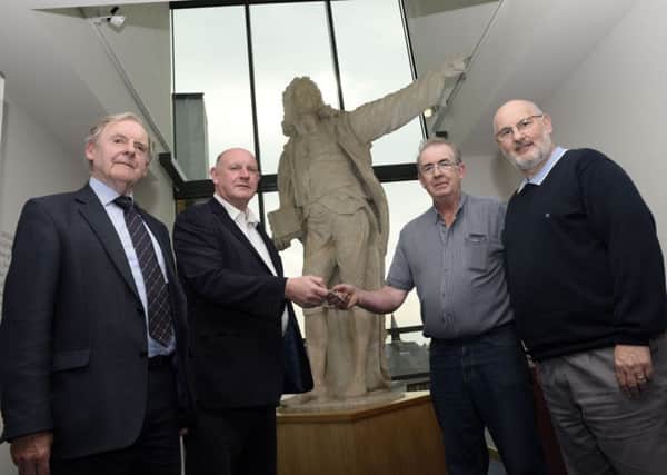Charlie McKelvey, second right, Site Manager for Tracey Brothers, hands over the keys of the Siege Museum to Billy Moore, Chair of The Siege Museum Management Committee. Included are Noel Moore, left, Treasurer, and Worthington McGrath, Secretary. INLS3715-102KM