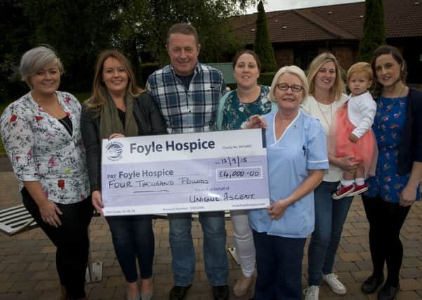 Group from Unique Ascent Rock Climbers pictured handing over a cheque for £4,000 to Nurse Breege McNutt, Foyle Hospice on Saturday afternoon last. From left are Jemma Sayers, Rachel Bruce, James McKittrick, Christine Devine, Linda Sayers with Aimee (1 year old) and Caroline Devine. DER3615MC042