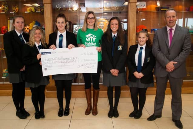 Carrickfergus College year 10 pupils presenting a cheque to Habitat for Humanity. Pictured are:  Bracken Bennett, Charley Robinson, Leah Clarke, Victoria Trimble, from Habitat for Humanity, Kara Luney, Brittany Bennett and principal Hedley Webb. INCT 37-753-CON