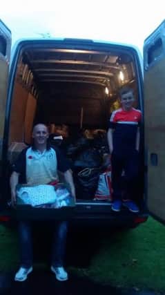 Nadine's husband Mathew, brother John loading up donations before delivery to Ballymena. inbm38-15 s