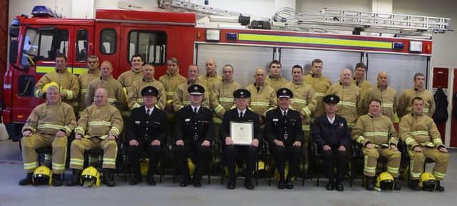 Watch Commander Hugh McGill with Ballycastle firefighters and senior officers at Hughs last night of duty
