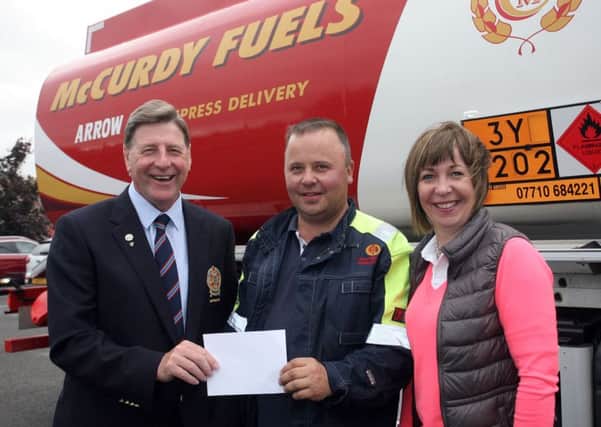 Bill McCurdy, of McCurdy Fuels, presents sponsorship for the McCurdy Fuels competition at Ballymena Golf Club to captain Henry Eagleson and Elaine Mark. INBT37-220AC