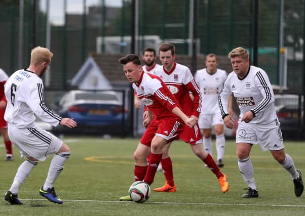Peter Thompson has little room for manoeuvre during Wakehurst Strollers' Irish Junior Cup tie against Annagh United Reserves on Saturday. Picture: Dylan McIlwaine.