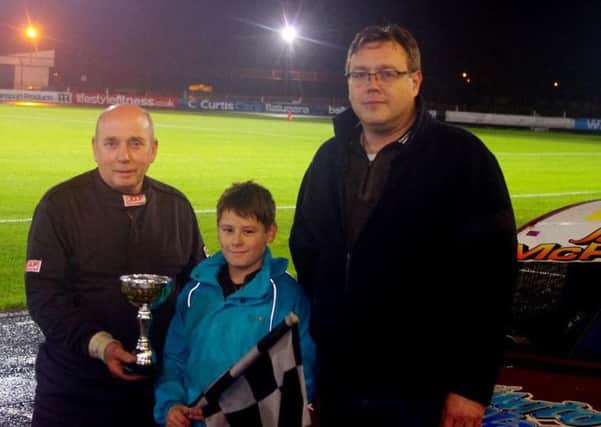 Ballymena's Joel McPeake won his first final at Raceway and collects the Junior Rod award from meeting sponsors Bobby Johnston (left) and Mark Frew. Picture: Davy Park.