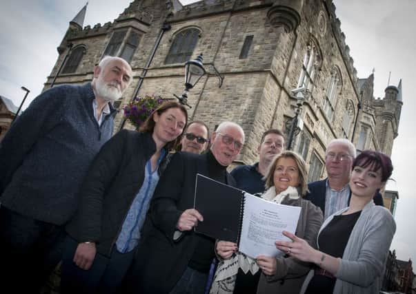 Playwright/author Roy Arbuckle pictured front centre with Gilly Campbell, Arts Council Northern Ireland, outside the Memorial Hall on Friday last. Included from left are Eamon Baker, Towards Understanding and Healing, Stephanie Hilditch, Siege Museum, Michael Nangle, Director, Paul McCole, Sandwich Company (main sponsors), James Rutherford, Society Social Club (hosts) and Nadine Sweeney, choreographer, Fireworks. INLS3615MC009