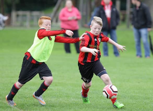 Action from the under-13 game between Hillsborough Boys and Glenavy, at Wallace Park. US1537-542cd  Picture: Cliff Donaldson