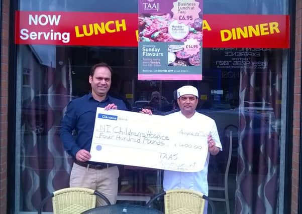 TAAJ owner Manjeev Sharma and chef Rama Nand Bhatt presenting the cheque to the NI Children's Hospice. INNT 38-827CON