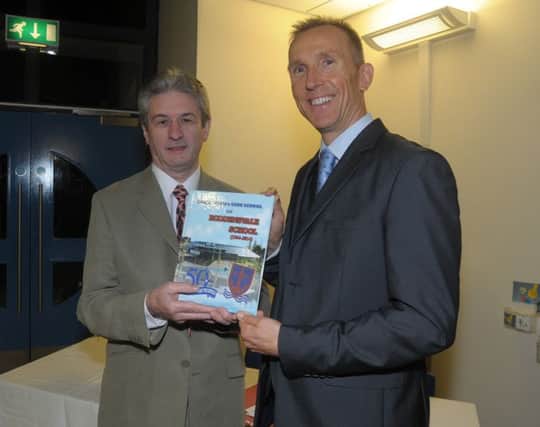 Author, Felix McKillop presents Mr John Madden, Principal Roddensvale School with a copy of his newest book, 50 years of Larne Special Care School and Roddensvale School INLT 43-200-AM