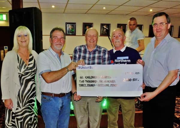 Marie Linthwaite (bar manager UTBC), Norman Davis, Andy Morrow, Tommy McCready (receiving cheque on behalf of the Children's Hospice) and Stevie Whan. INNT 38-833CON